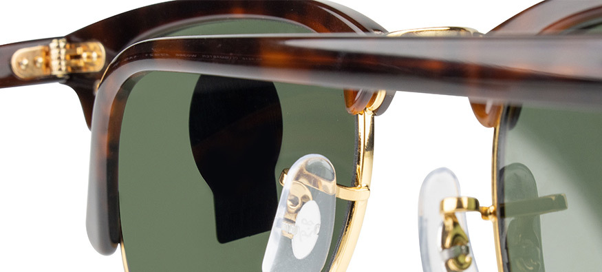 Ray Ban sunglasses with Ray Ban logo embossed in the centre of nose pads