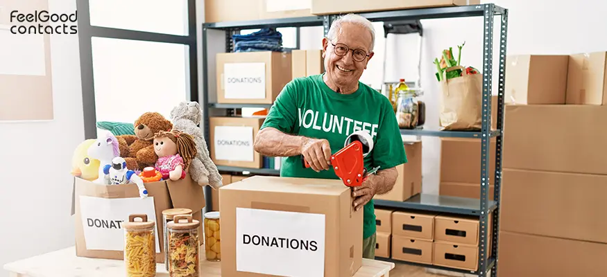 An elderly man volunteering at a charity shop