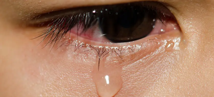 tears falling from someones eye