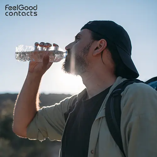 A man drinking water on a hike