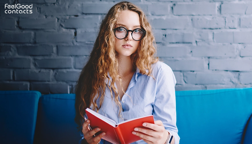 Woman in glasses reading a book