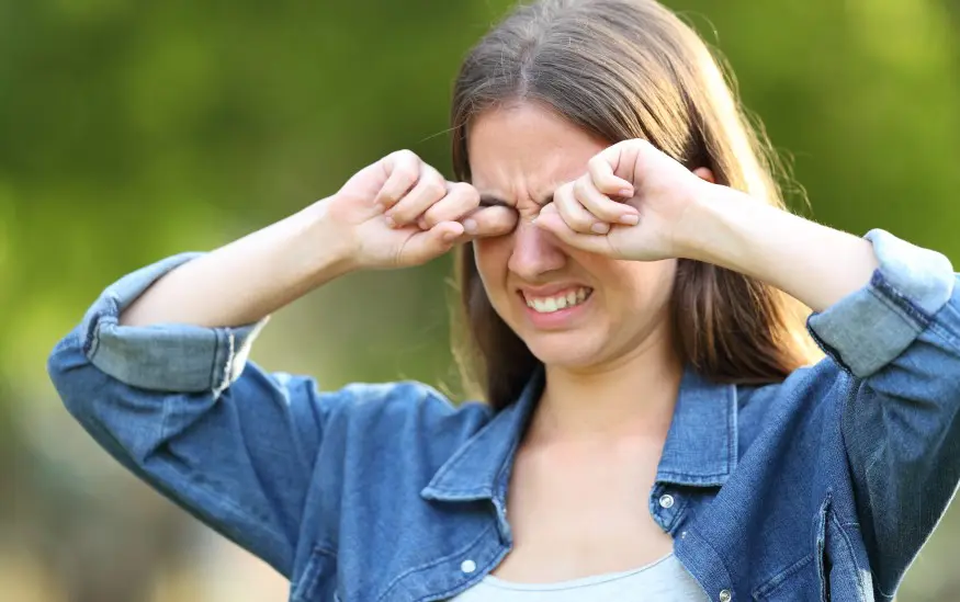 woman itching eyes