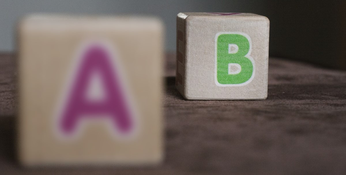 wooden cubes with letters an example of the focus of the vision with hyperopia
