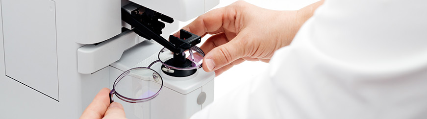 optician measuring and preparing glasses